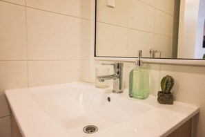 Bright and modern bathroom with stylish accents, perfect for a refreshing start to your day.