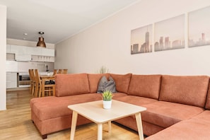 Spacious living room with plush seating and a warm, inviting color palette.