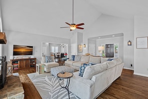 Back Porch Bliss-Inviting living area with large sectional, TV and lake views.