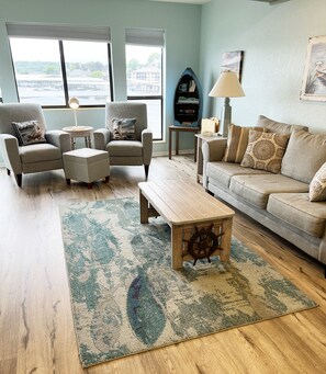 Huge living room with wood burning fireplace plenty of seating and sofa sleper