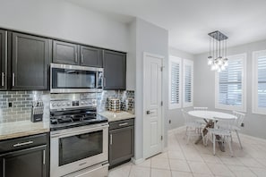 Stylish kitchen and dining area with sleek finishes.