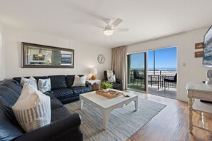 Wake up to breathtaking views right from your couch in this bright, beachy living space.