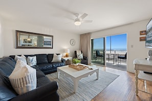 Wake up to breathtaking views right from your couch in this bright, beachy living space.