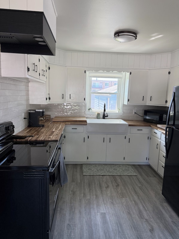 New appliances in a bright clean kitchen with butcher block countertops