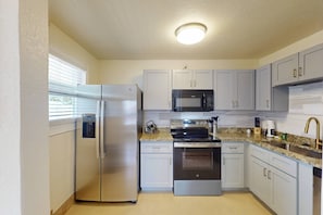 Two full kitchens with granite countertops, stainless steel appliances, and everything needed to cook and dine in