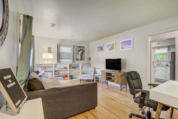 Welcome to Gracie's Hideaway! Open-concept living space with a cozy seating area, entertainment setup, and built-in shelves that add character and function..