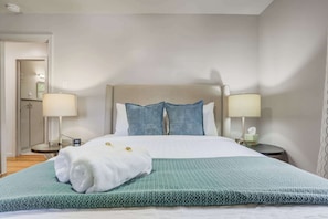 Comfortable second bedroom featuring soft lighting, fresh linens, and a calming color palette for a peaceful stay.