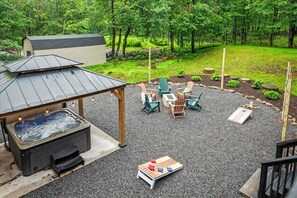 Take in the full beauty of your getaway — from the spacious outdoor patio and hot tub to the inviting deck and game-ready yard. Your perfect retreat, all in one stunning shot!