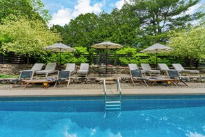 Relax and unwind in the pool area—complete with lounge seating and serene surroundings for the perfect day in the sun.