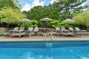 Relax and unwind in the pool area—complete with lounge seating and serene surroundings for the perfect day in the sun.