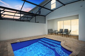 Unwind by the private pool at night in your cozy outdoor living room.