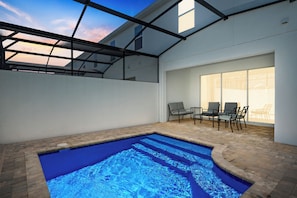 Unwind by the private pool at night in your cozy outdoor living room.