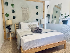 Bedroom: Queen Size Bed, clothing chest, Iron, Smart TV, Wifi, and Air Conditioning.