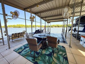 Relax under the shaded dock with fans, comfortable seating, and easy water access—ideal for fishing, lounging, or launching a kayak.