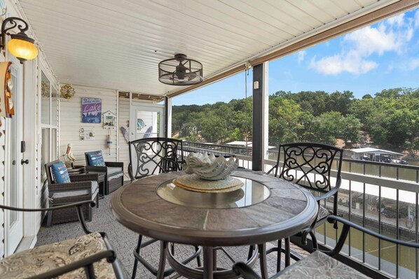 Relax and unwind in the cozy screened-in porch—perfect for morning coffee or evening chats