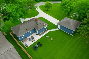 Bird’s-eye view of your private lake retreat—spacious yard, fire pit, garage, and plenty of room to relax or play.