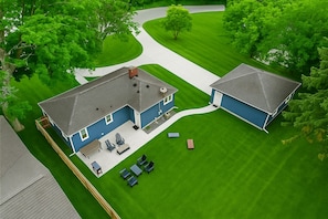 Bird’s-eye view of your private lake retreat—spacious yard, fire pit, garage, and plenty of room to relax or play.