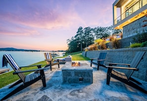 Cozy up beside the fire pit as the sun dips below the lake—serene evenings and golden hour views await.