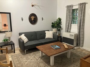 Hang out in the cozy living room with some TV. The couch is also a futon bed.