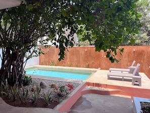 Pool with sundeck, poolside lounger and cooler.