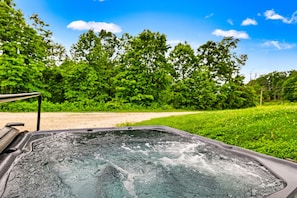 Take a dip in our 4 person hot tub on the back side of the cabin
