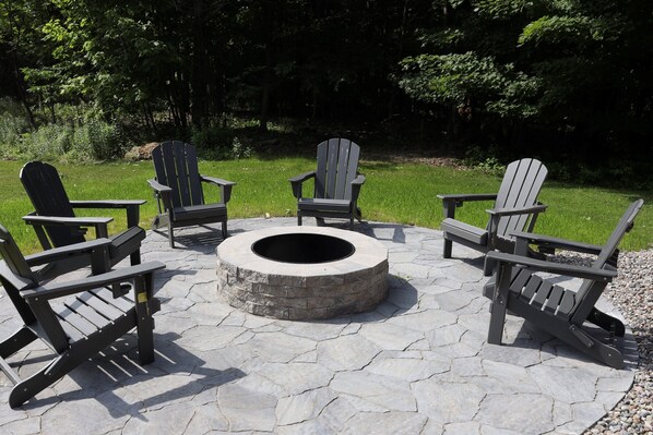 Crackling flames, cozy chairs, and a stone patio made for memory-making - this fire pit sets the vibe.