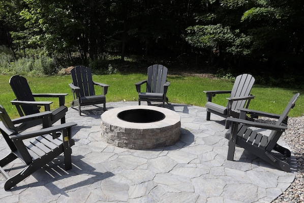 Crackling flames, cozy chairs, and a stone patio made for memory-making - this fire pit sets the vibe.