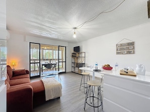 Imaginez-vous partager un repas avec vue sur la véranda. L'espace lumineux et aéré offre une transition harmonieuse entre l'intérieur et l'extérieur, parfait pour la détente.