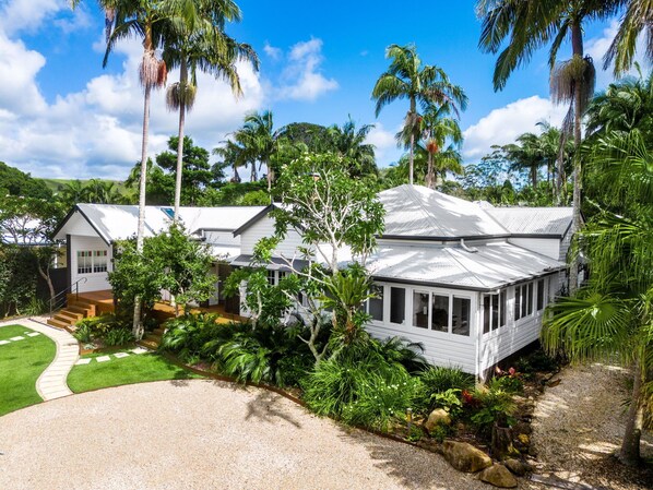 Beautifully landscaped entrance framed by tropical gardens, leading to your private oasis. The villa’s bright, breezy façade hints at the comfort and calm that awaits inside.