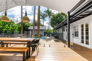Gather with friends and family on the expansive timber deck, featuring a generous dining area, designer lighting, and direct access to the magnesium pool—perfect for long lunches and relaxed evenings outdoors.