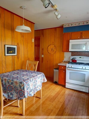 Eat- in kitchen,  gas stove, microwave, coffee maker w reusable filter, dishes
