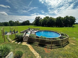 Our large outdoor pool with deck and lounge chairs!
