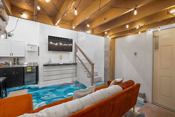 Living room with smart tv, and couch