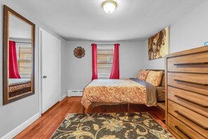 Comfortable bedroom with a queen-size bed and ample storage space.