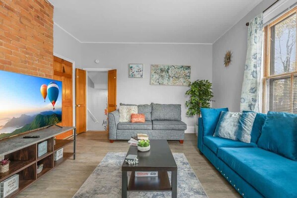 Bright living room with a cozy sofa and natural light.