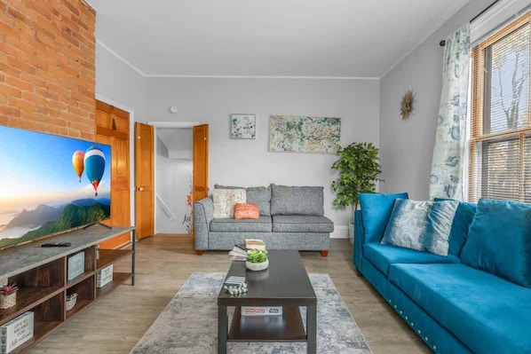 Bright living room with a cozy sofa and natural light.