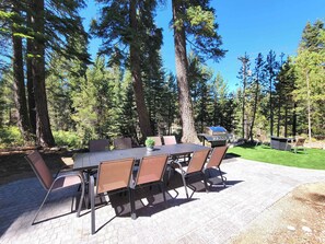 Exterior: Forest-side patio with dining for 10, gas grill, propane fire pit, and outdoor lounge area