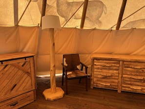 Custom cabin-style furniture, including a knotty pine dresser, side tables, and a cowhide leather reading chair, adds rustic elegance and ample storage. And a fold-out Murphy queen bed.
