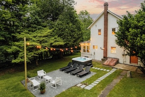 The backyard offers the perfect escape. A private haven for relaxation with open space, cozy seating, and peaceful natural surroundings.