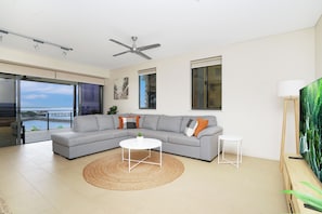 Large modular sofa, spacious lounge area that steps straight out onto balcony.