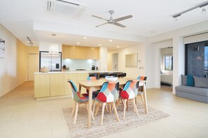 Dining setting for 6 guests, with modular sofa by window for reading nook.