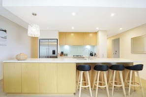 Breakfast bar stools and spacious kitchen, well equipped with all necessary appliances.