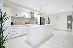 Spacious and well equipped kitchen with island bench.
