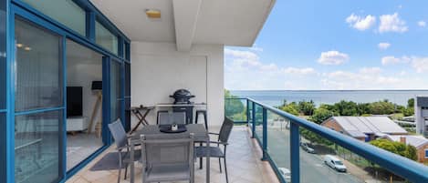 Dining for 4 guests on private balcony with BBQ.