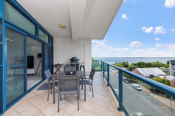 Dining for 4 guests on private balcony with BBQ.