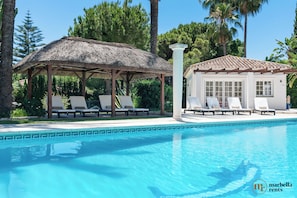Sun loungers at private pool.