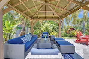Elegant seating area and gazebo by the pool