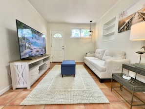 This space invites you to kick off your shoes, sink into comfort, and make yourself at home.