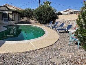 Backyard pool is ready for lounging or sipping your coffee in the morning.
