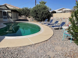 Backyard pool is ready for lounging or sipping your coffee in the morning.